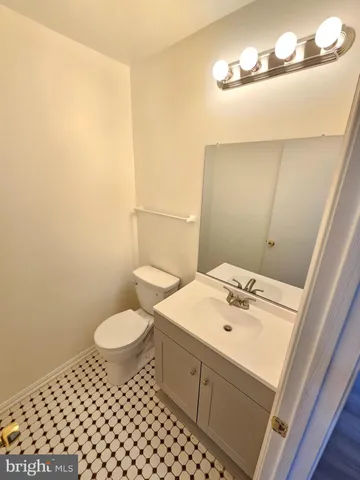 a bathroom with a sink toilet and mirror