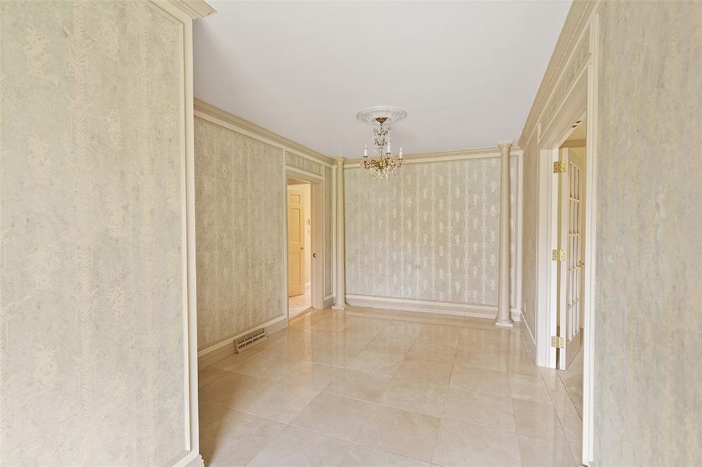 2676 Sunset Lane Allison Park, PA 15101 - Photo 5 of 25 Prepare to be amazed when entering this beautifully updated home. The foyer includes silk wallpaper, marble tile, a custom chandelier, crown molding, a stained glass door leading to the hallway and french doors leading to the living room.