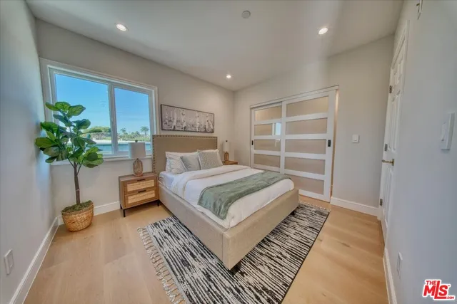 a bedroom with a bed and a potted plant