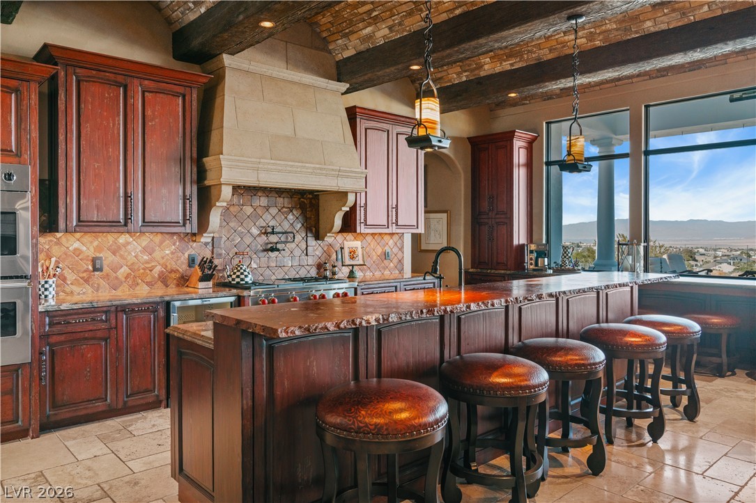 1123 Christian Road Henderson, NV 89002 - Photo 17 of 94 Prepare culinary delights in this spacious kitchen featuring a large island, premium appliances, and a breathtaking panoramic view.