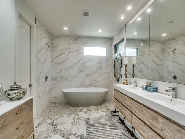 a spacious bathroom with a bathtub sink a toilet and a shower