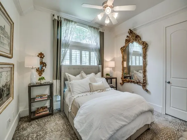 a spacious bedroom with a bed and a chandelier
