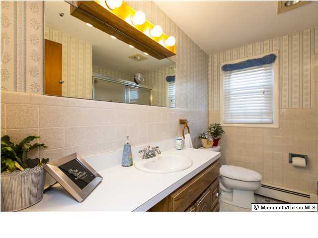 41 Albany Road Neptune Township, NJ 07753 - Photo 11 of 23 a bathroom with a sink a toilet and mirror