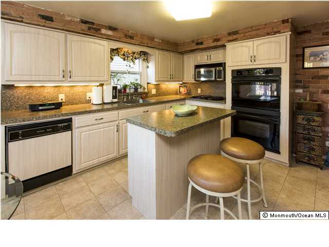 41 Albany Road Neptune Township, NJ 07753 - Photo 8 of 23 a kitchen with stainless steel appliances granite countertop a stove a sink and a microwave