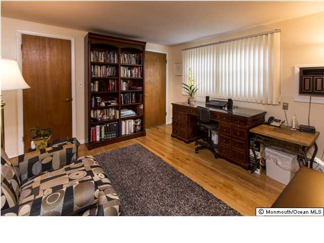 41 Albany Road Neptune Township, NJ 07753 - Photo 10 of 23 a living room with furniture a flat screen tv and bookshelf