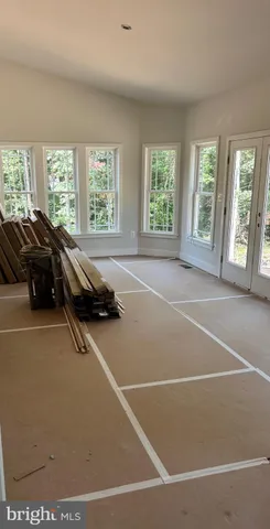 a room with gym equipment and windows