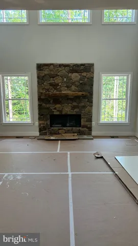 a living room with a fireplace and a table