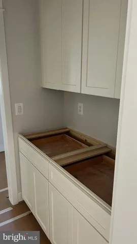 a utility room with granite countertop cabinets and utility