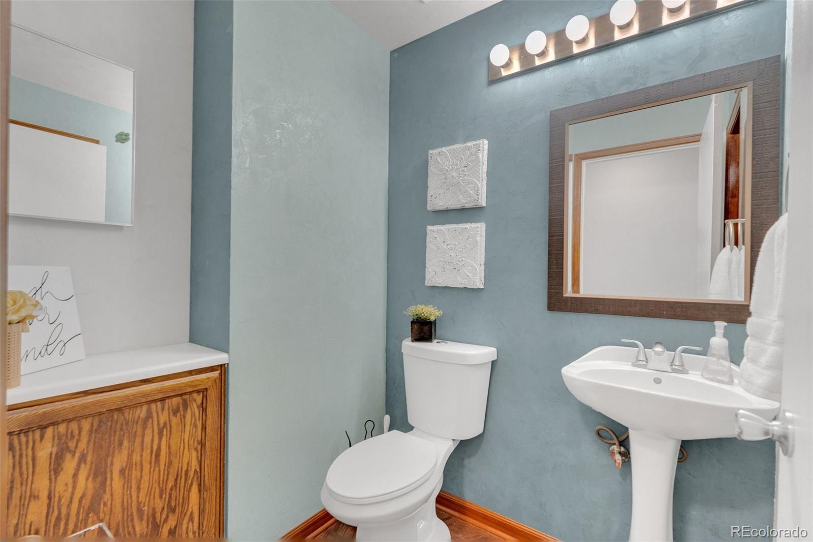 4320 Genoa Street Denver, CO 80249 - Photo 17 of 48 a bathroom with a sink toilet and mirror