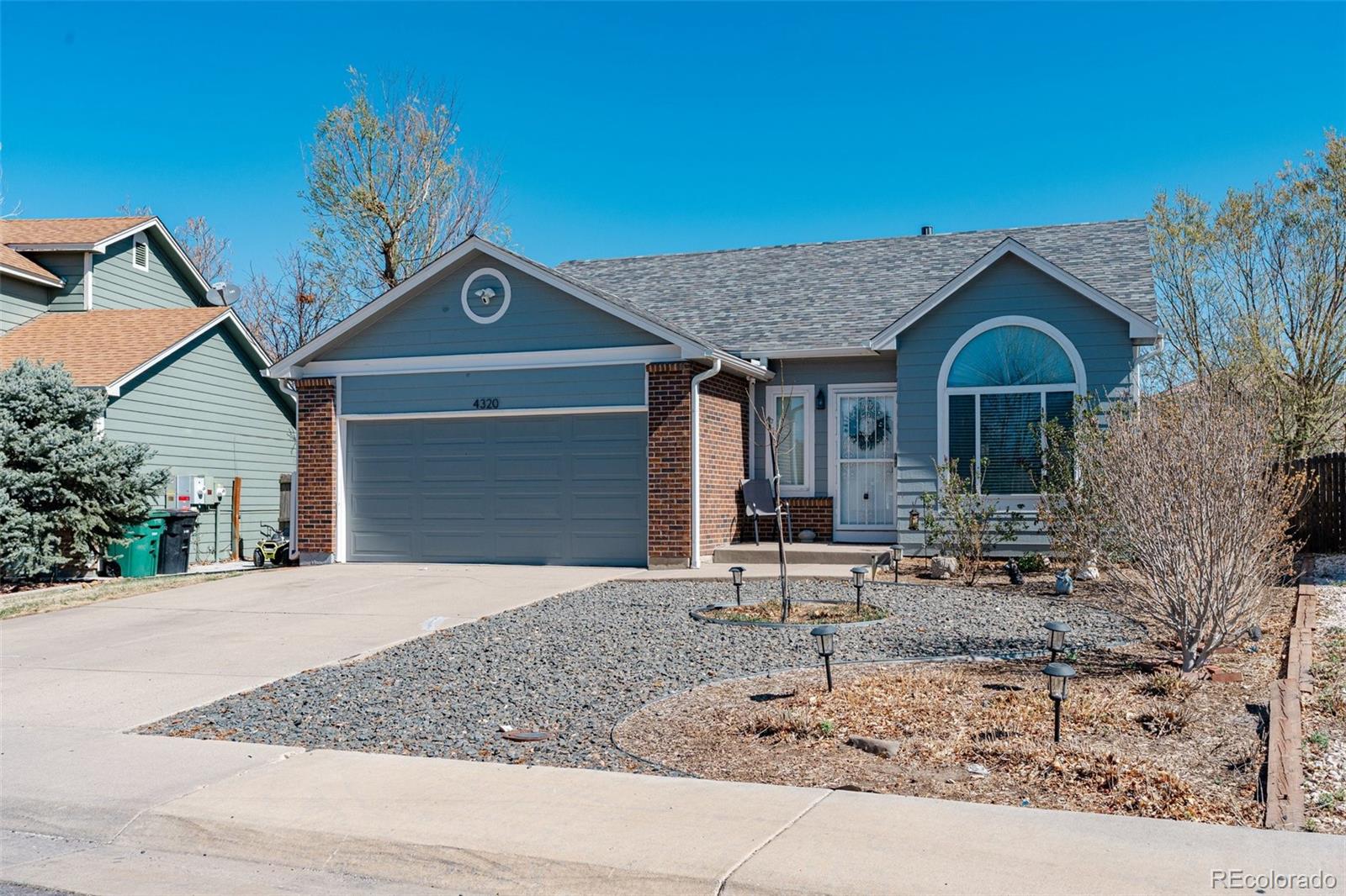 4320 Genoa Street Denver, CO 80249 - Photo 2 of 48 a front view of a house with garden