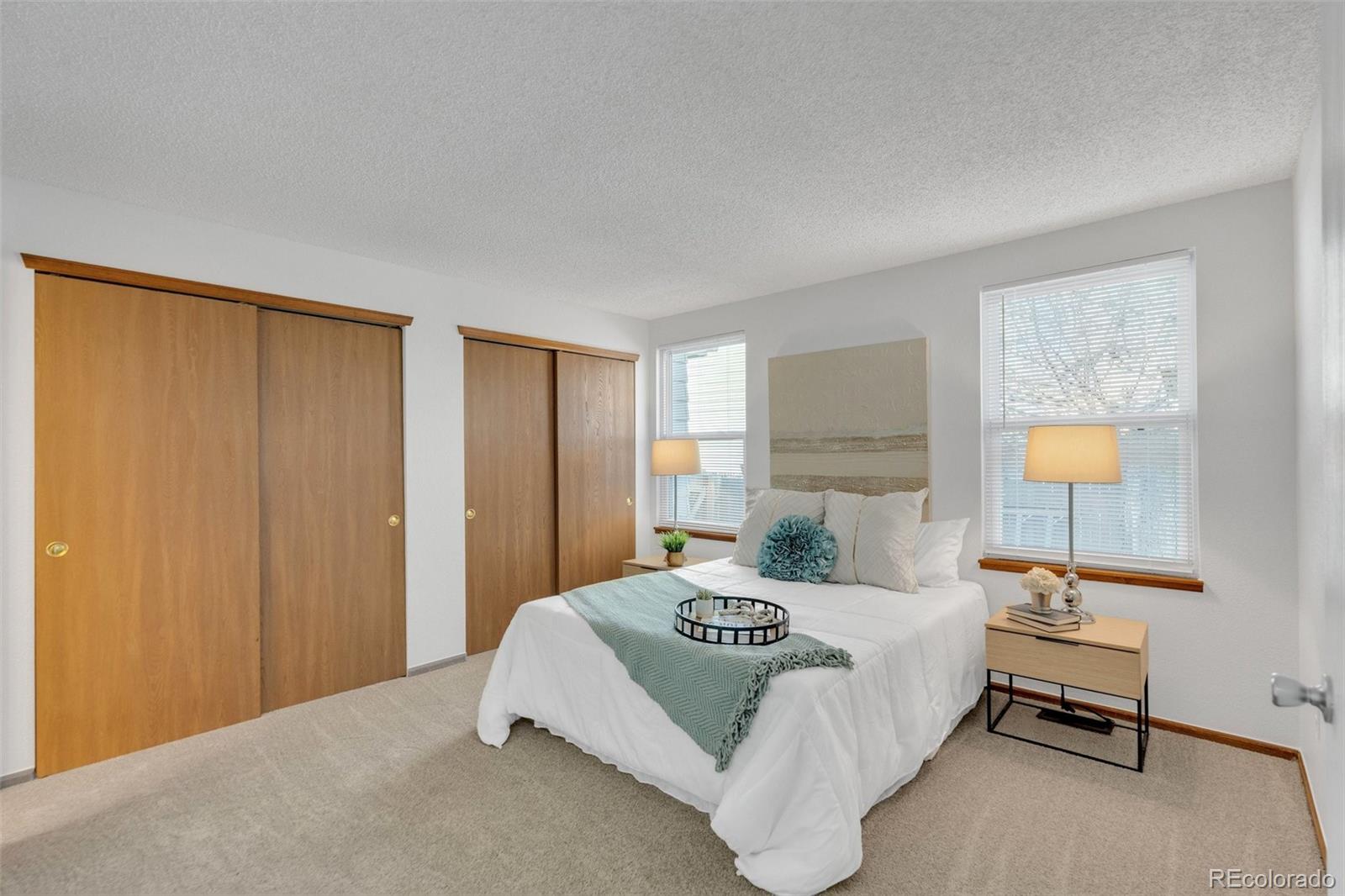 4320 Genoa Street Denver, CO 80249 - Photo 21 of 48 a bedroom with a bed and lamp