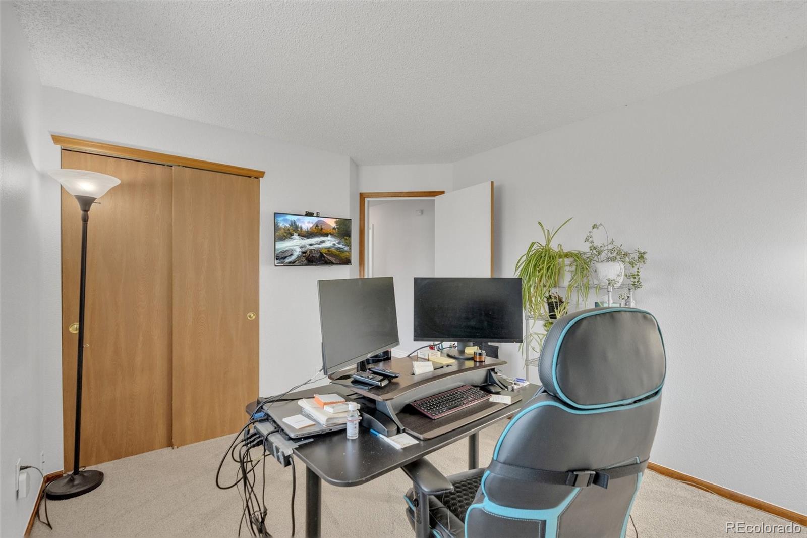 4320 Genoa Street Denver, CO 80249 - Photo 22 of 48 a workspace with furniture and a mirror
