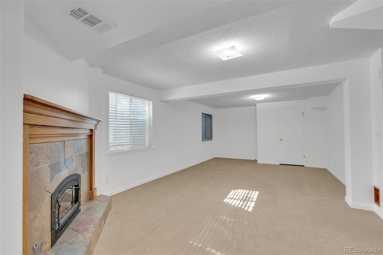 4320 Genoa Street Denver, CO 80249 - Photo 24 of 48 a view of an empty room with a fireplace