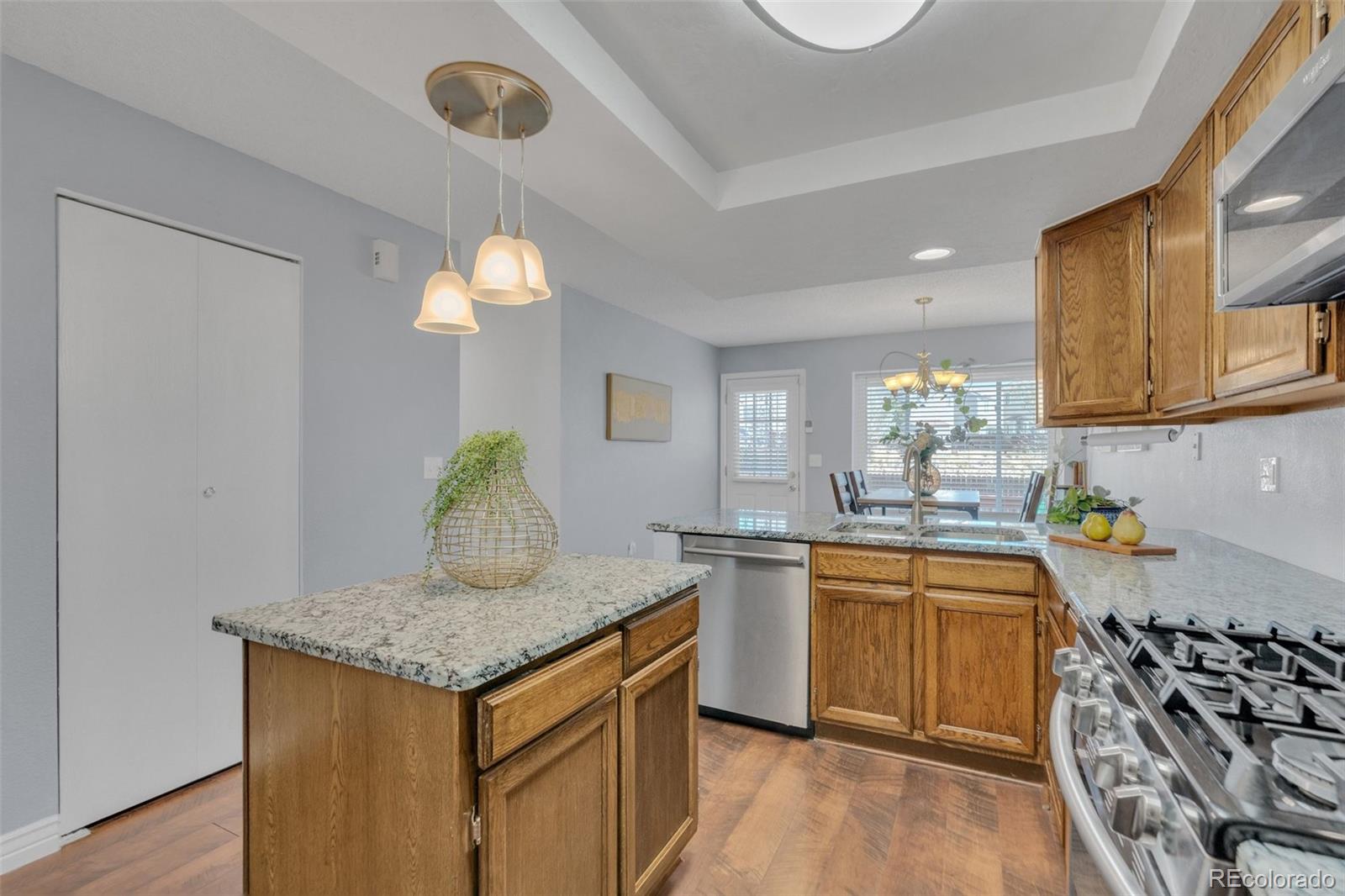 4320 Genoa Street Denver, CO 80249 - Photo 29 of 48 a kitchen with granite countertop a sink and a stove