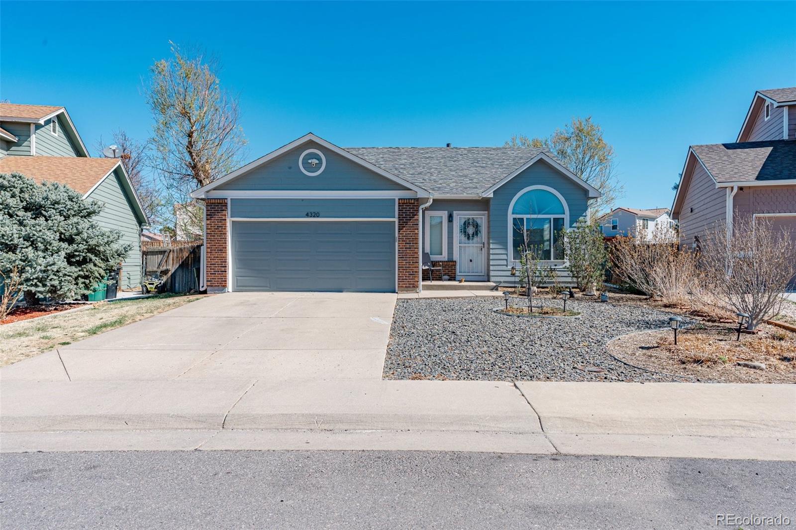 4320 Genoa Street Denver, CO 80249 - Photo 3 of 48 a front view of a house with garden