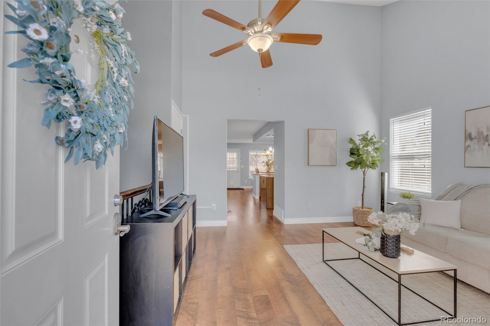 4320 Genoa Street Denver, CO 80249 - Photo 31 of 48 a living room with furniture and a chandelier