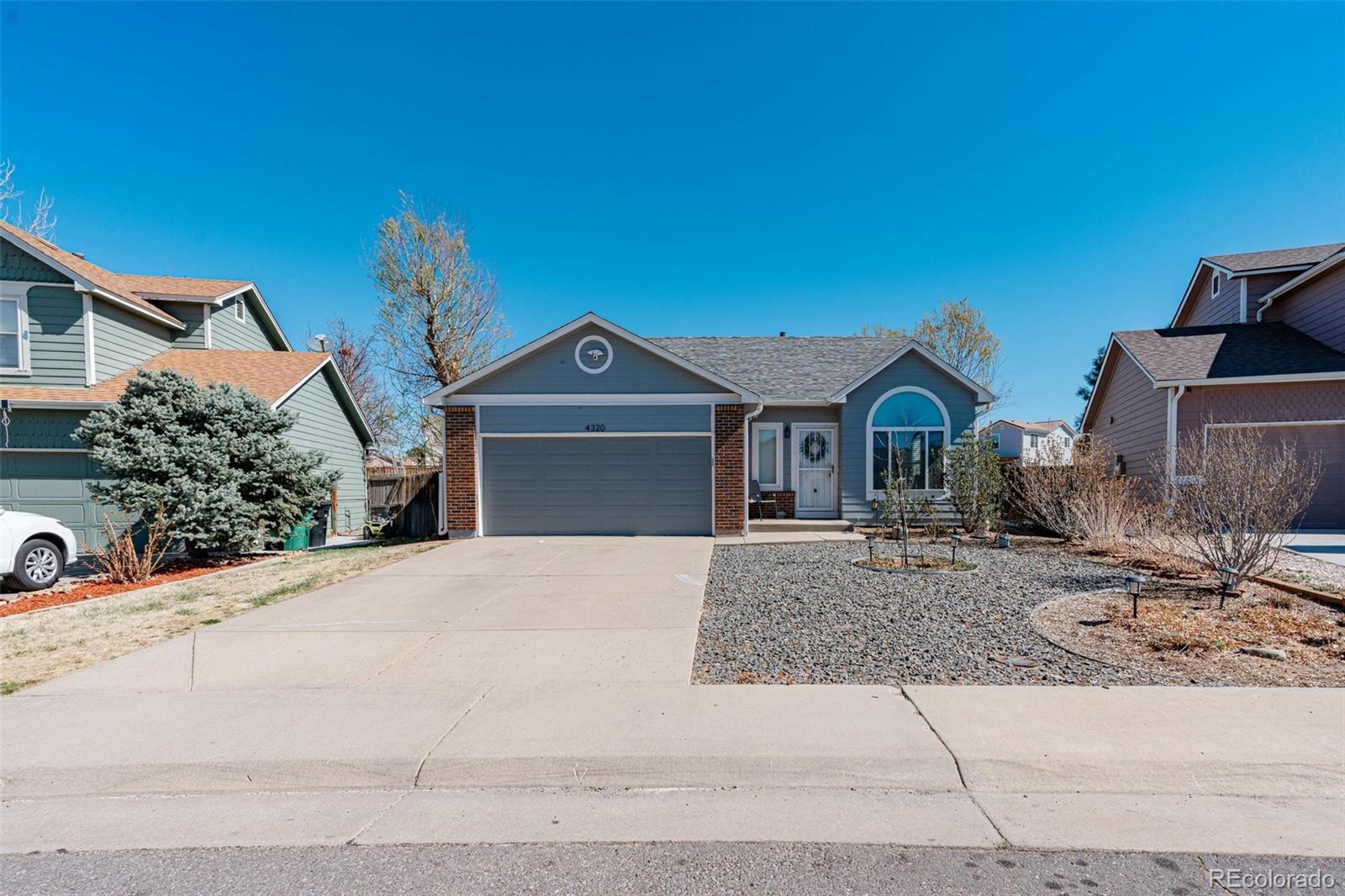 4320 Genoa Street Denver, CO 80249 - Photo 40 of 48 a front view of a house with trees