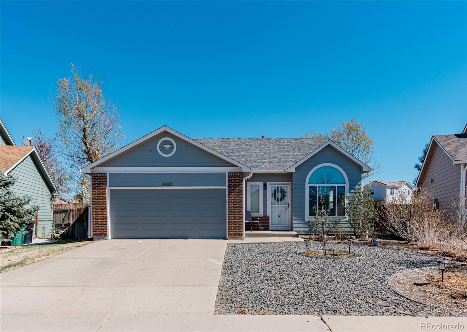 4320 Genoa Street Denver, CO 80249 - Photo 4 of 48 a front view of a house with garden