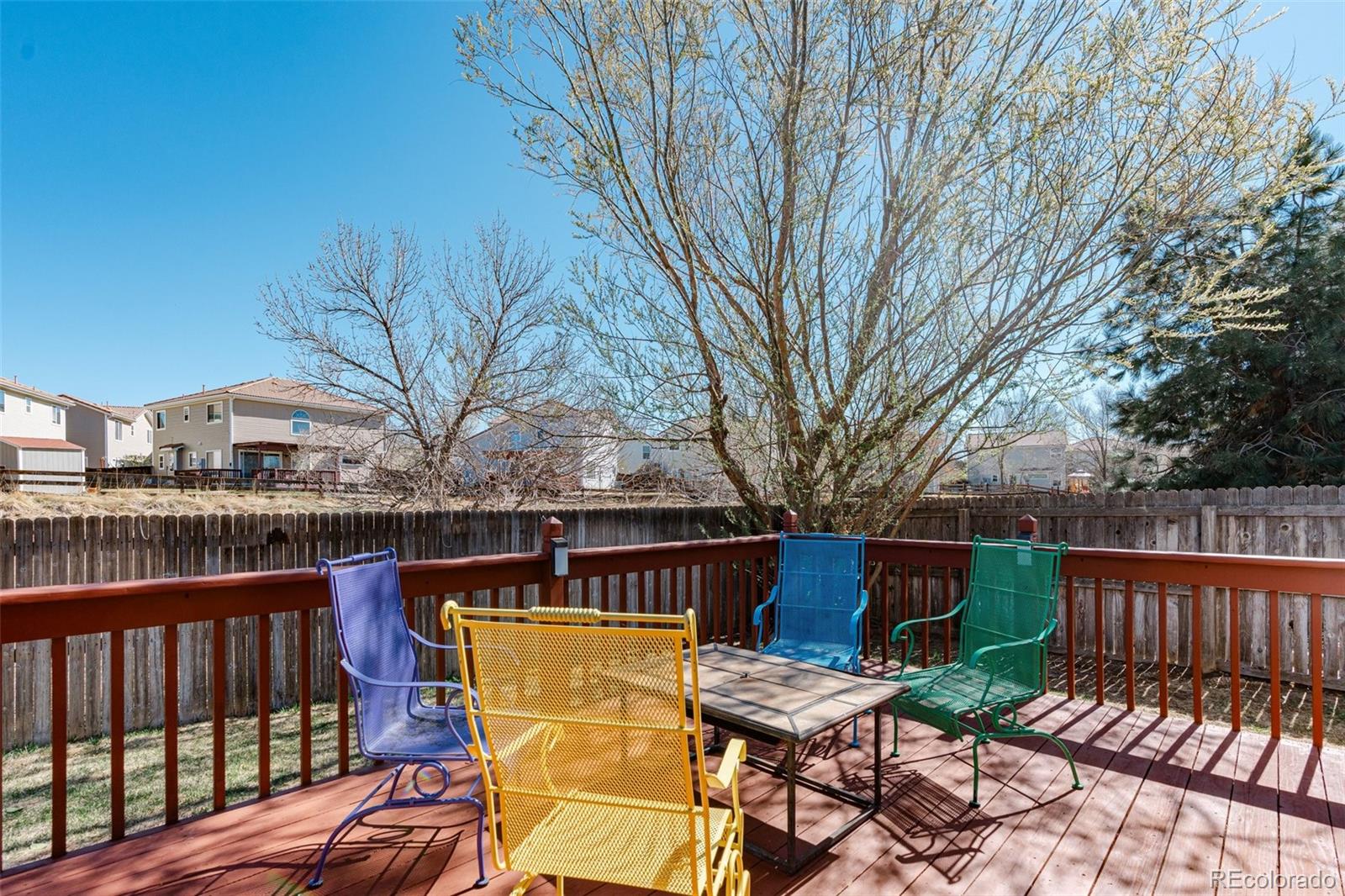 4320 Genoa Street Denver, CO 80249 - Photo 45 of 48 a view of a patio with table and chairs under an umbrella with wooden floor