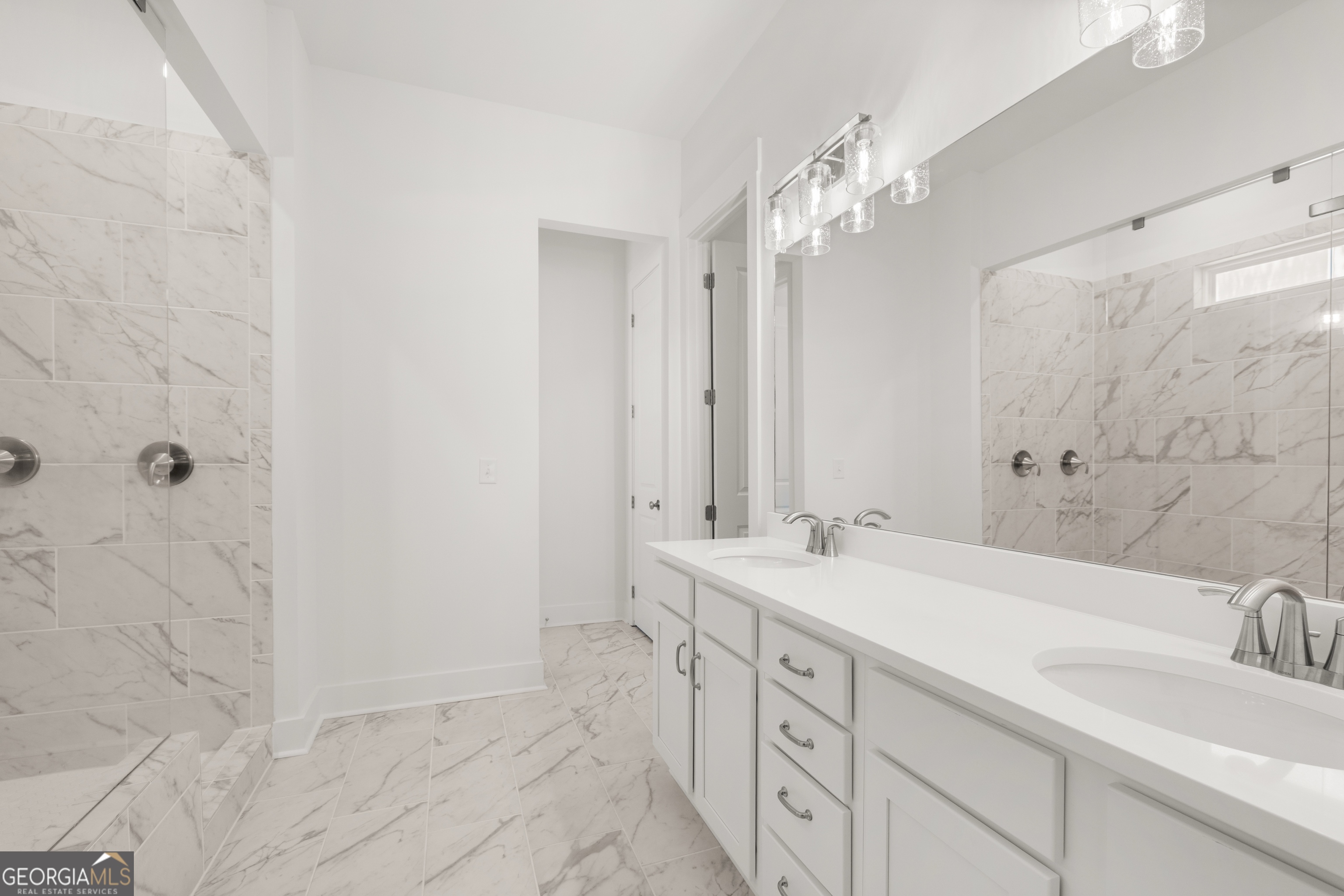 15 Overview Court Hoschton, GA 30548 - Photo 24 of 43 a bathroom with a double vanity sink a mirror and a bathtub