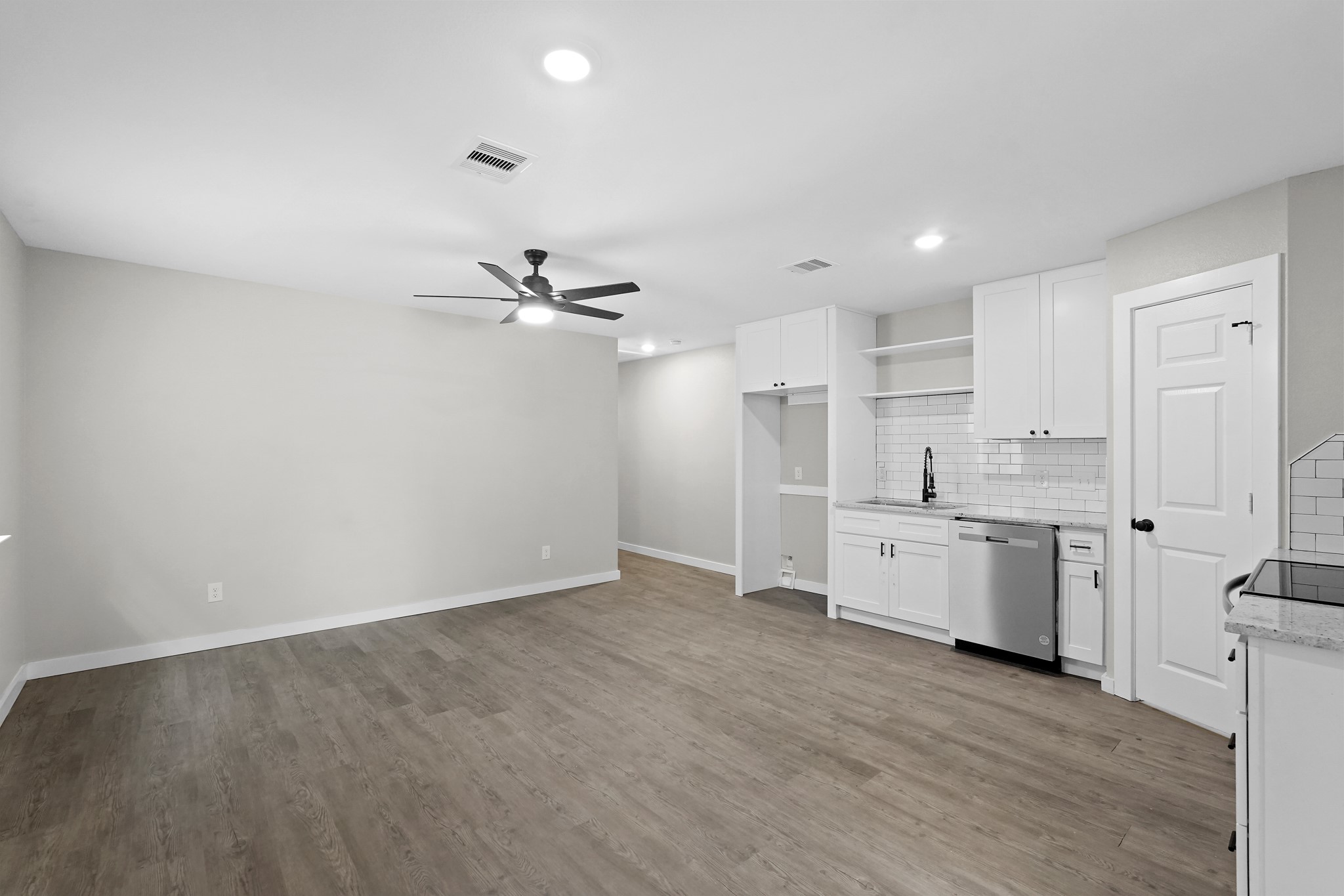 6121 Ridgemont Street Houston, TX 77087 - Photo 1 of 15 a view of a kitchen with a sink and dishwasher a refrigerator with wooden floor