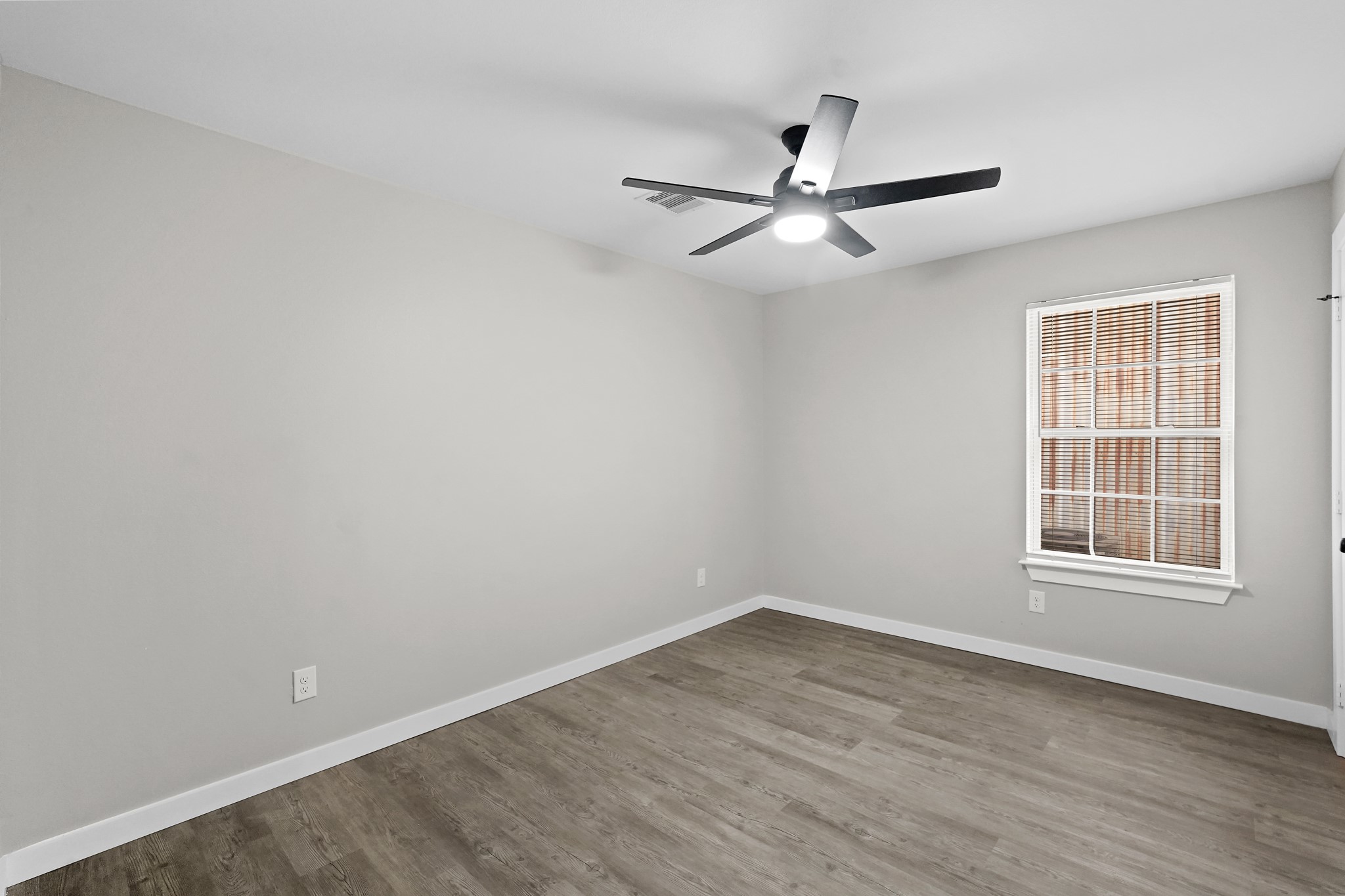 6121 Ridgemont Street Houston, TX 77087 - Photo 13 of 15 wooden floor in an empty room with a window