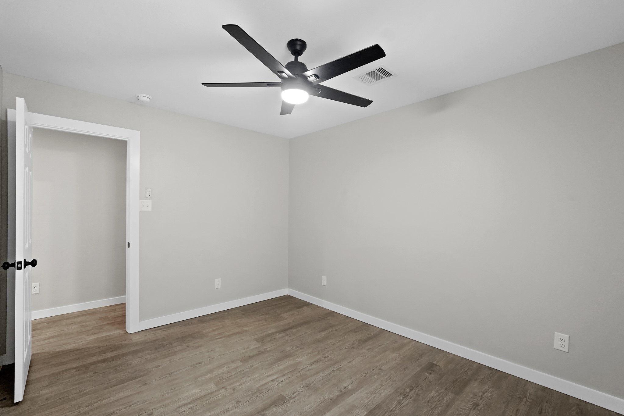 6121 Ridgemont Street Houston, TX 77087 - Photo 14 of 15 an empty room with wooden floor and ceiling fan