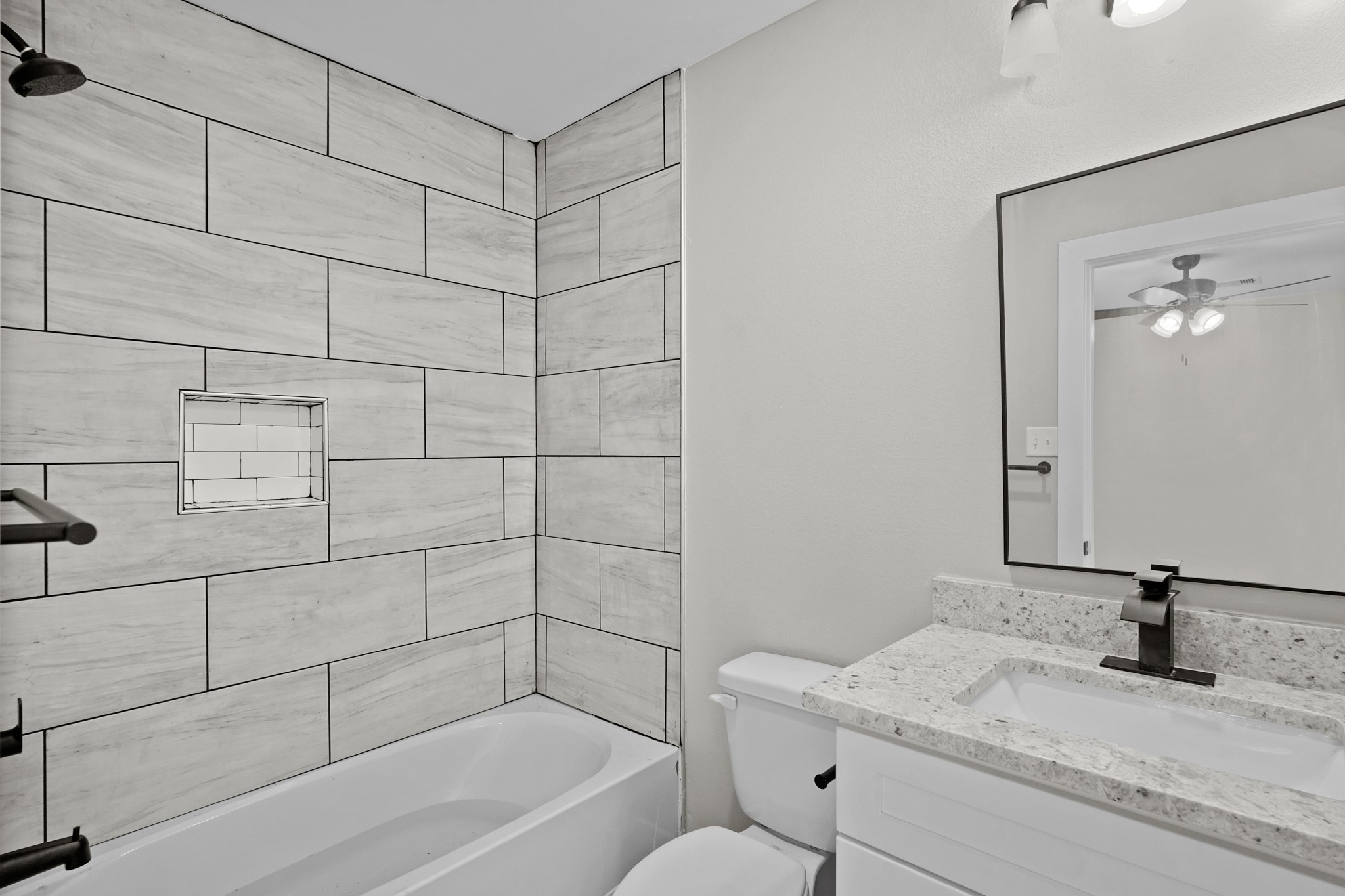 6121 Ridgemont Street Houston, TX 77087 - Photo 7 of 15 a bathroom with a granite countertop sink a toilet and shower