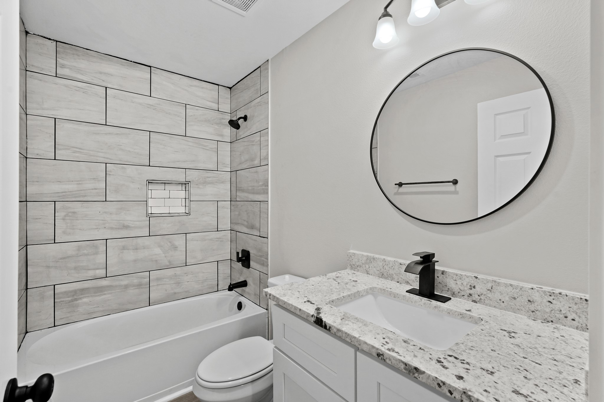 6121 Ridgemont Street Houston, TX 77087 - Photo 8 of 15 a bathroom with a granite countertop sink a toilet and a mirror