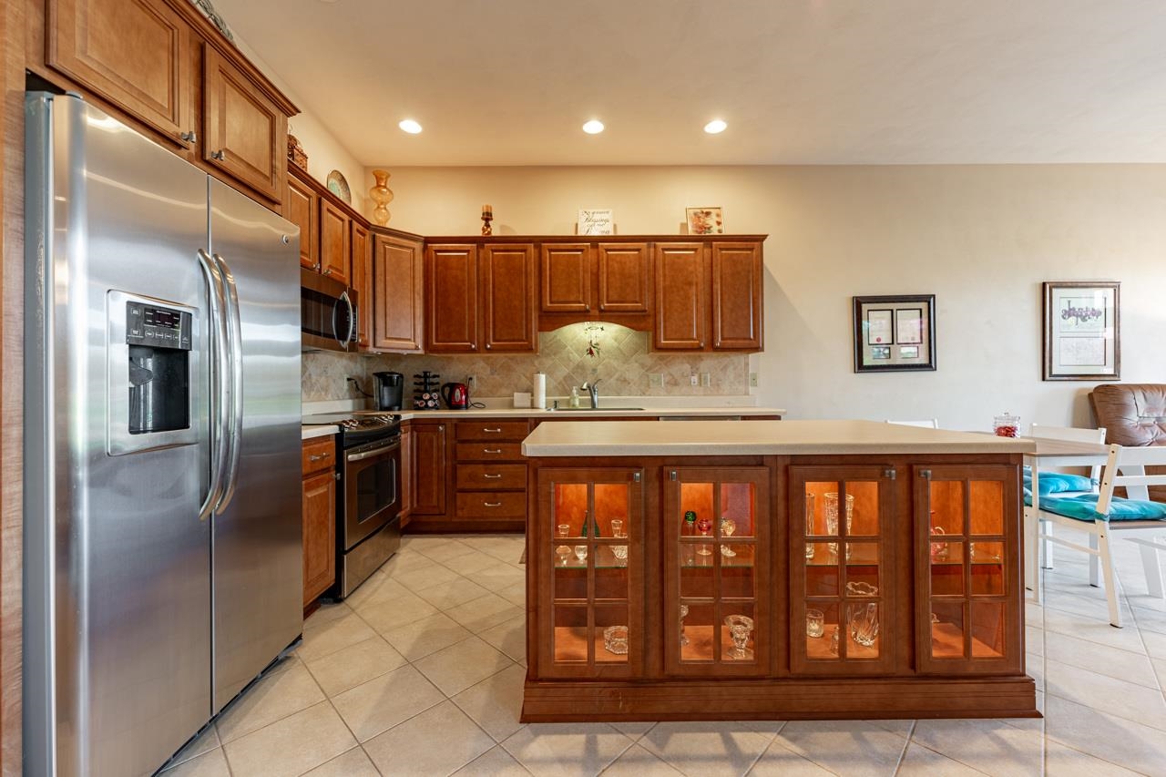 5624 Spring Brook Road Rockford, IL 61114 - Photo 9 of 34 a kitchen with stainless steel appliances granite countertop a refrigerator a sink a stove and a wooden cabinets