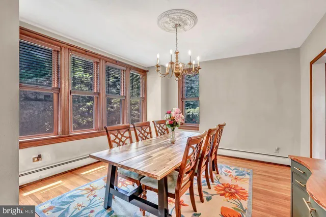 a dining room with furniture a chandelier and window