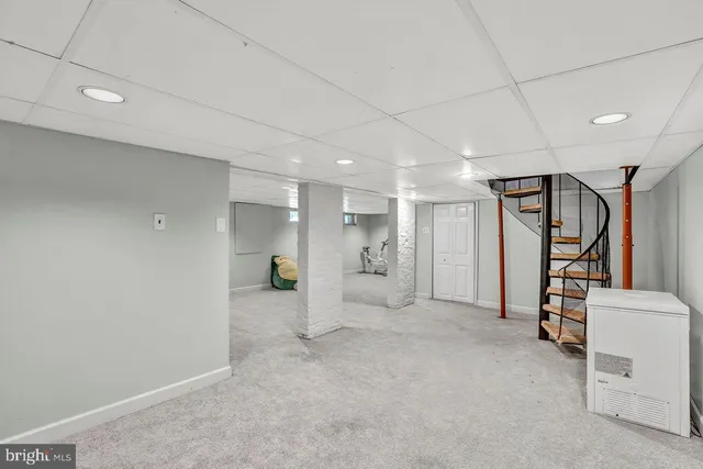 a bedroom with a bed lamp and a window