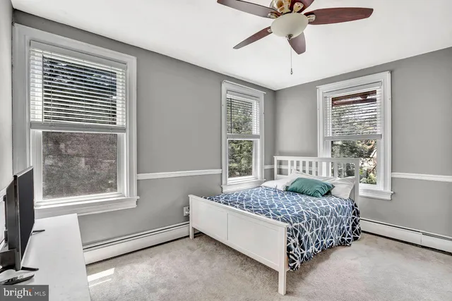 a room with a chair and white walls