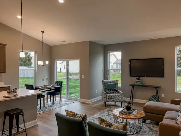 a living room with furniture a wooden floor and a flat screen tv