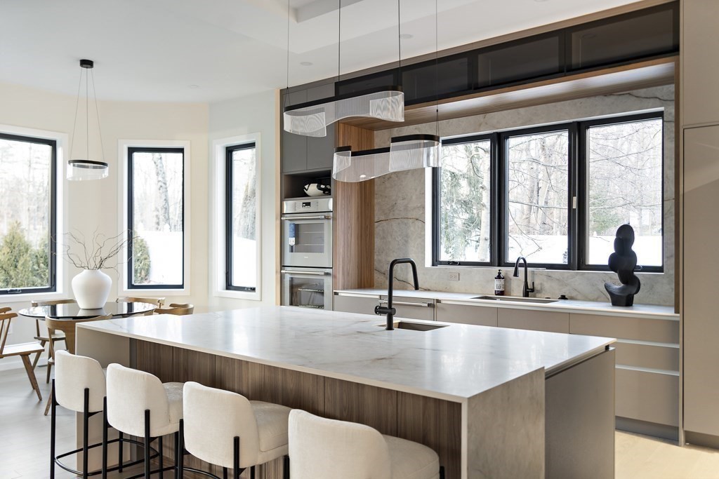 109 Wiswall Road Newton, MA 02459 - Photo 13 of 36 a kitchen with a table chairs and a sink