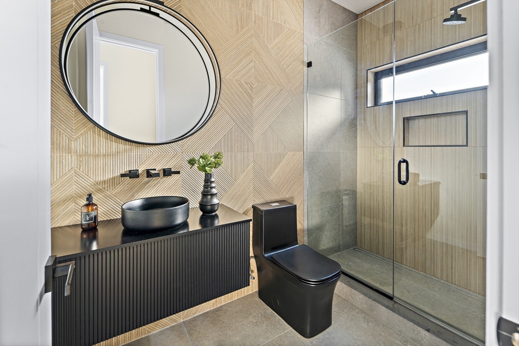 109 Wiswall Road Newton, MA 02459 - Photo 19 of 36 a bathroom with a sink a mirror and a shower