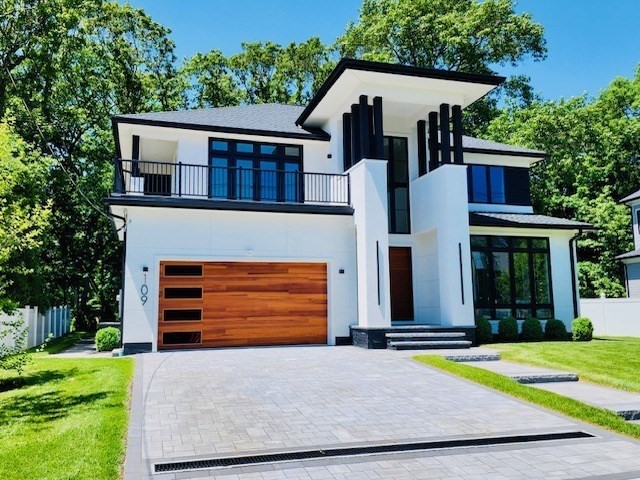 109 Wiswall Road Newton, MA 02459 - Photo 2 of 36 a front view of a house with a yard and garage