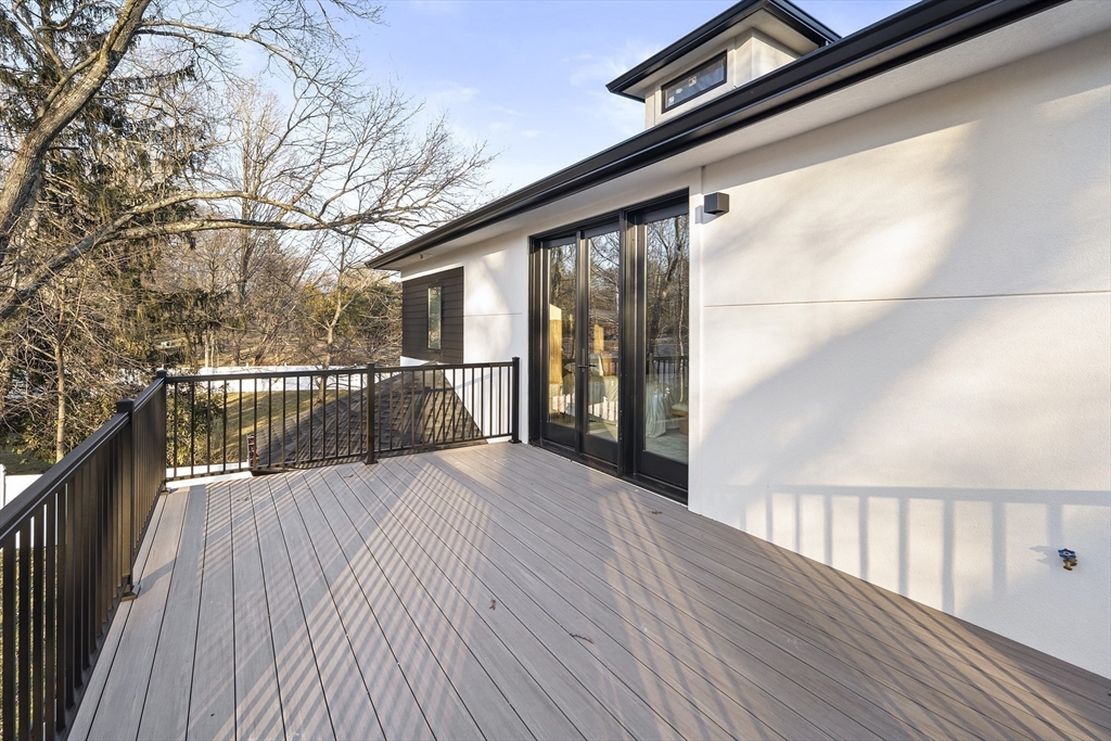 109 Wiswall Road Newton, MA 02459 - Photo 25 of 36 a view of backyard with wooden floor and fence