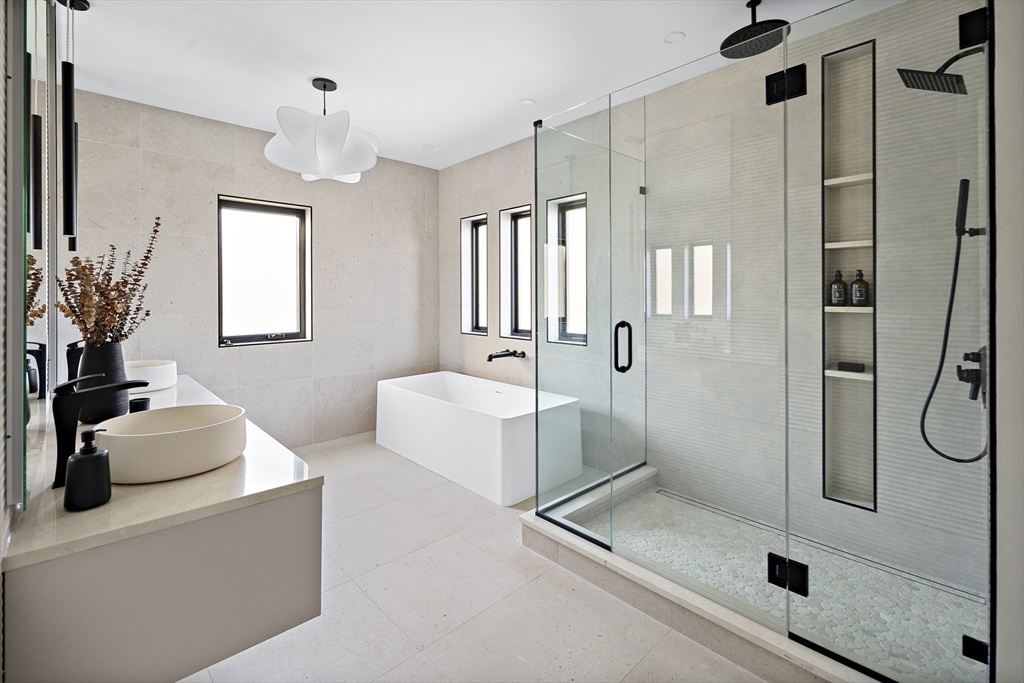 109 Wiswall Road Newton, MA 02459 - Photo 27 of 36 a bathroom with a tub sink a mirror a shower and glass door