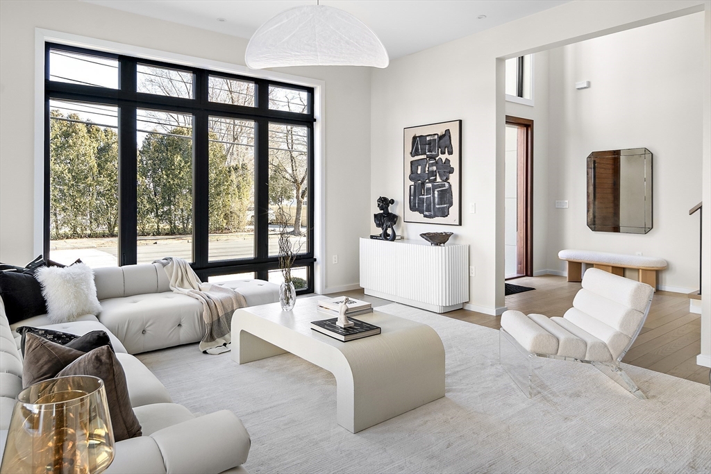 109 Wiswall Road Newton, MA 02459 - Photo 10 of 36 a living room with furniture and large windows
