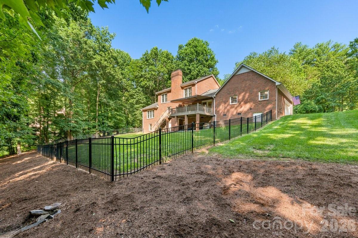 207 Lost Corner Road Morganton, NC 28655 - Photo 6 of 46 a view of a brick house with a yard and a large tree