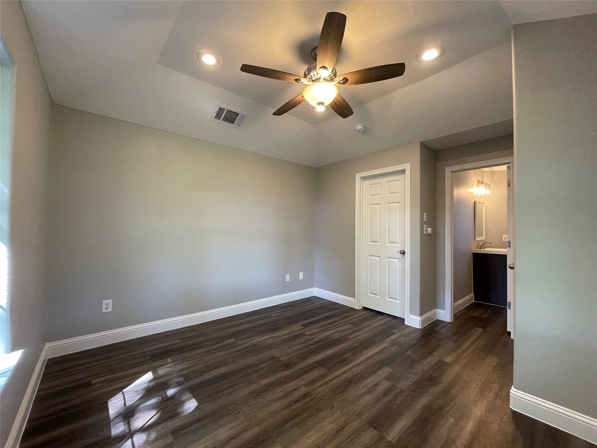 2004 Maple Street Georgetown, TX 78626 - Photo 22 of 31 Spacious room featuring wood-finish flooring, light gray wall tones, and white baseboards
