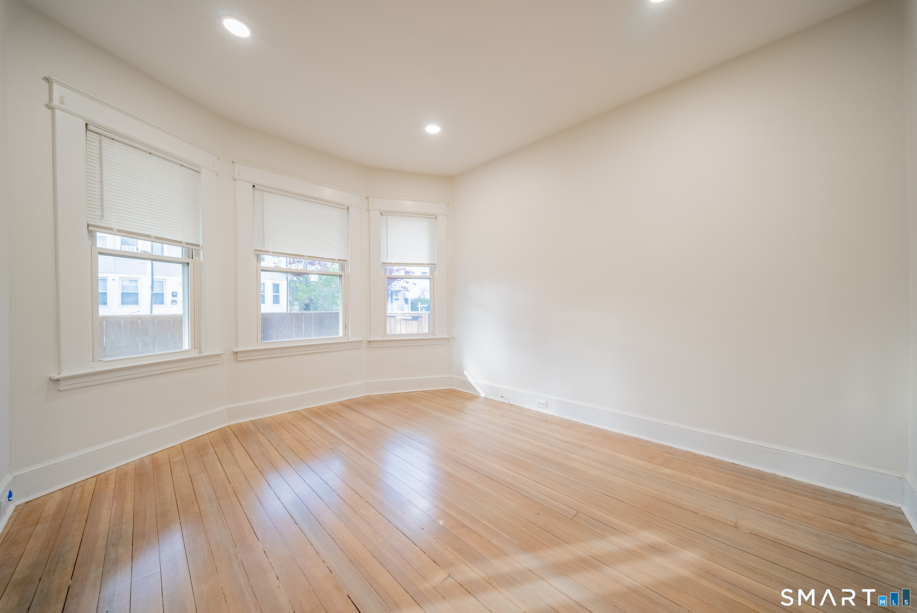 50 Jones Street West Haven, CT 06516 - Photo 5 of 21 an empty room with wooden floor and windows
