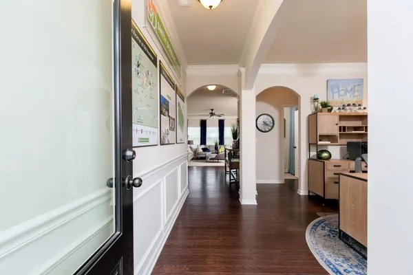 a view of a living room with furniture and wooden floor