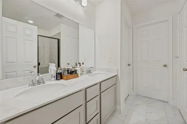 a bathroom with a glass shower door