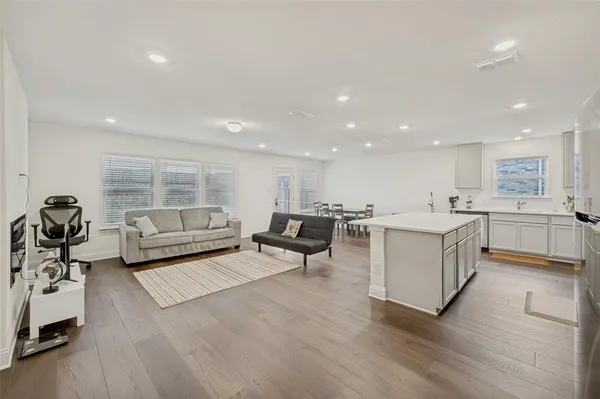 a living room with furniture and a wooden floor