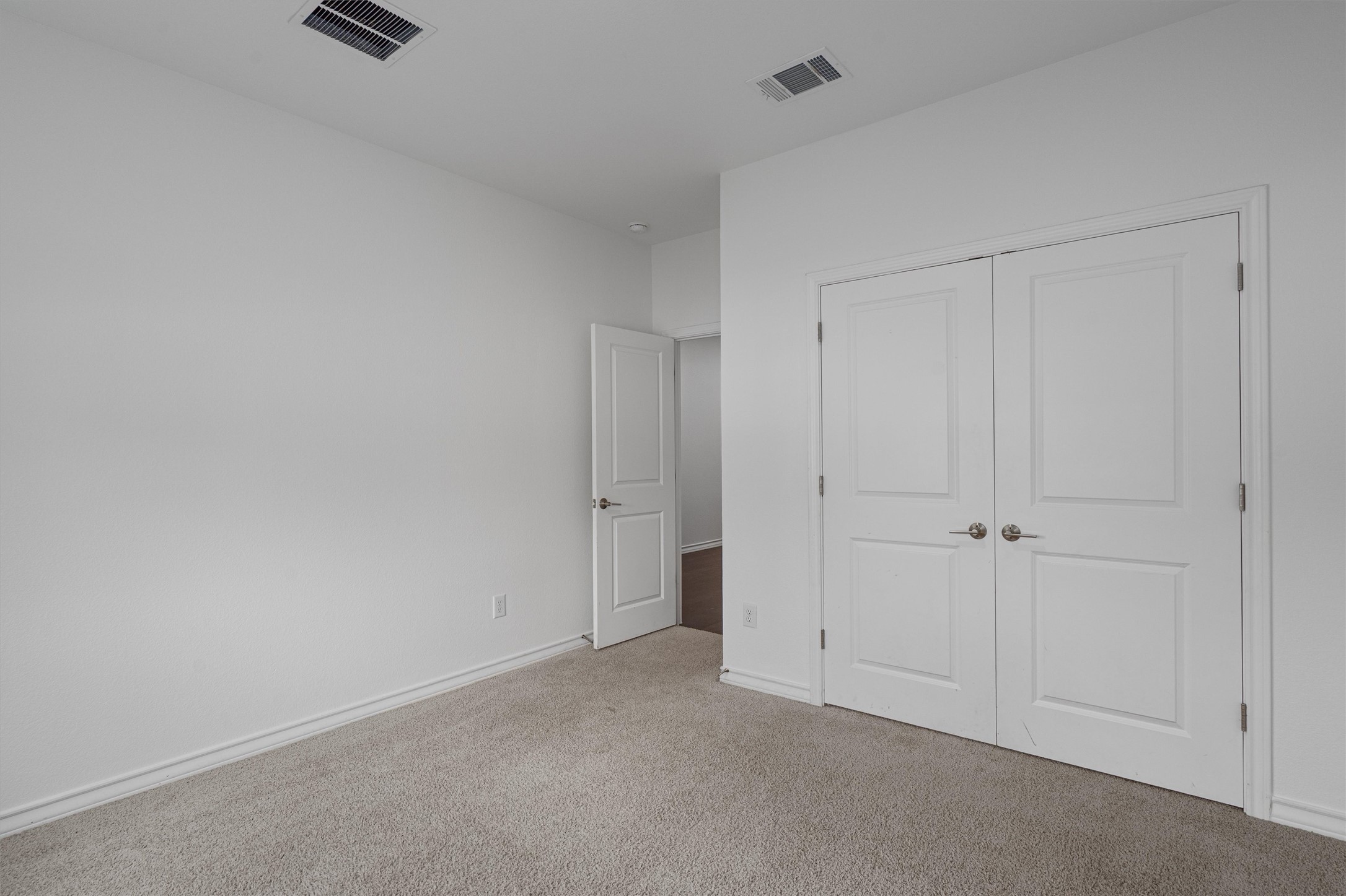 104 Stinchcomb Road Hutto, TX 78634 - Photo 23 of 40 Bedroom 2 is located at the front of the home and features a walk-in closet, making it a comfortable and functional secondary bedroom. It sits near the full bathroom shared with Bedroom 3.