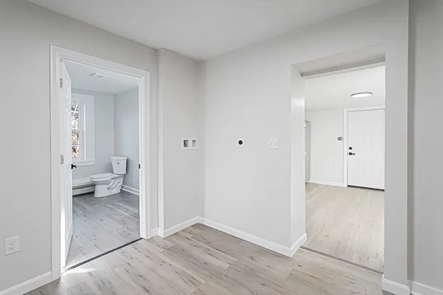 a bathroom with bathtub and window