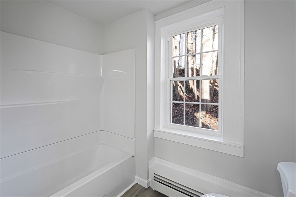 757 Main Street, Unit A Southbridge, MA 01550 - Photo 13 of 32 a bathroom with bathtub and window