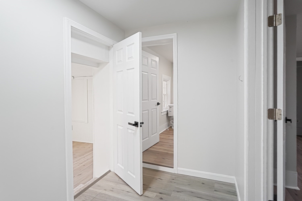757 Main Street, Unit A Southbridge, MA 01550 - Photo 20 of 32 a view of a hallway with wooden floor and staircase